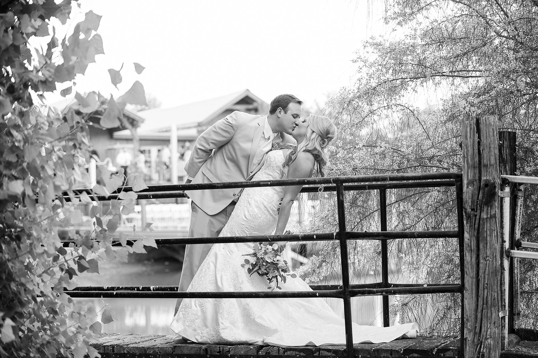 Windmill Winery Wedding Groom Bride Romantic Kissing Bridge Phoenix Arizona Photo