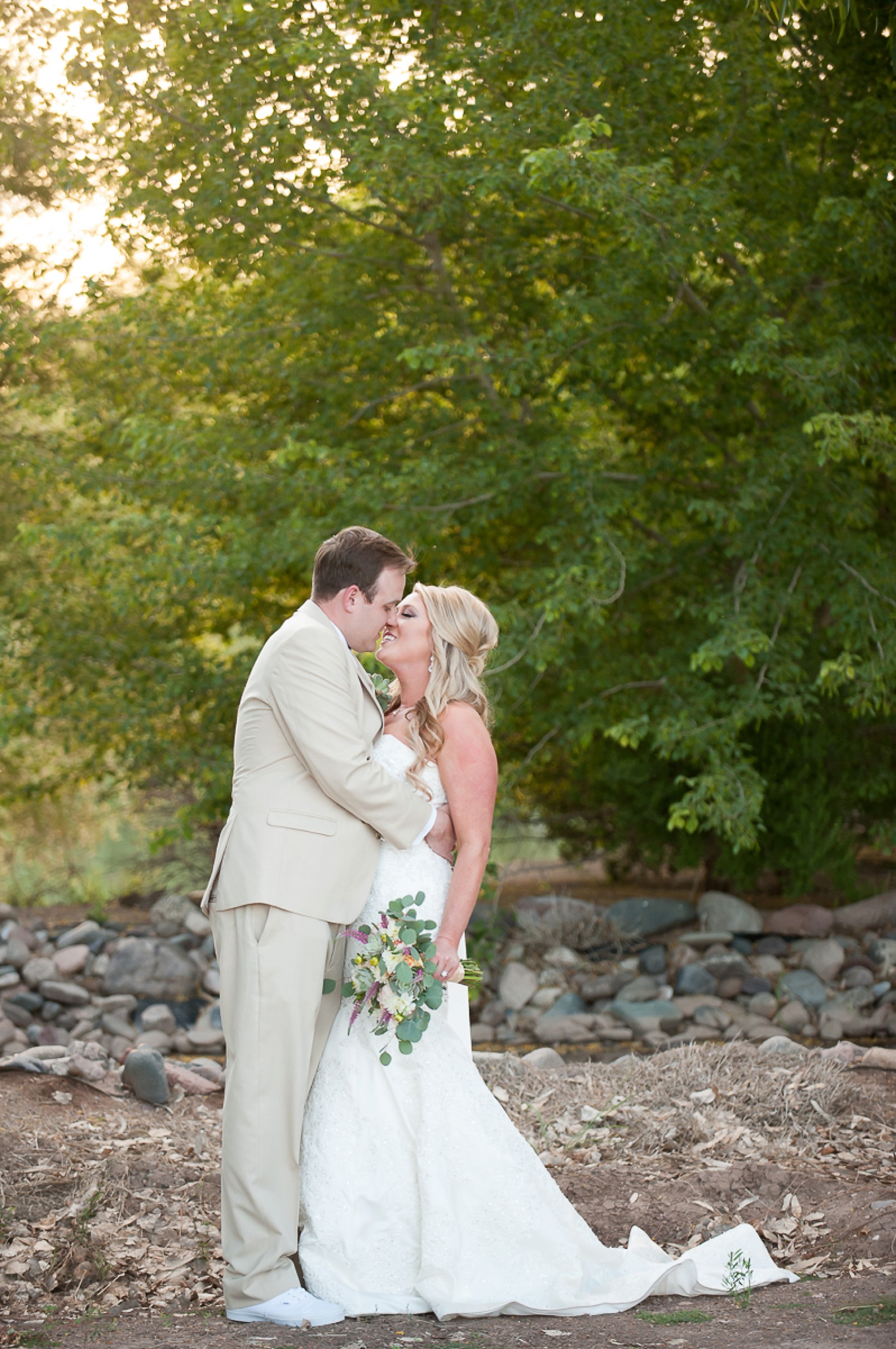 Windmill Winery Wedding Bride Groom Kissing Romantic Greenery Phoenix Arizona Photo
