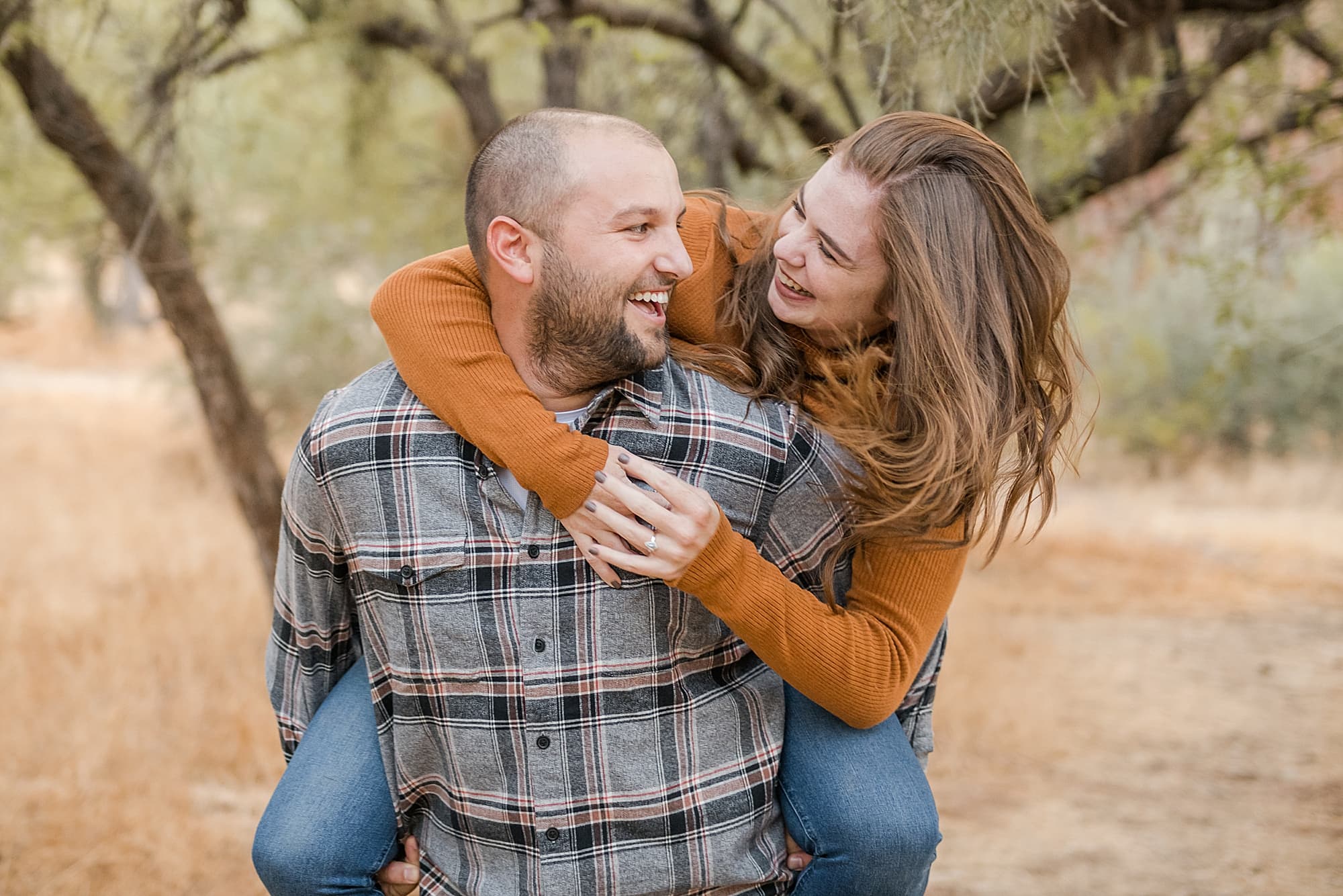 Warm fall engagement session at Coon Bluff Couple laughing