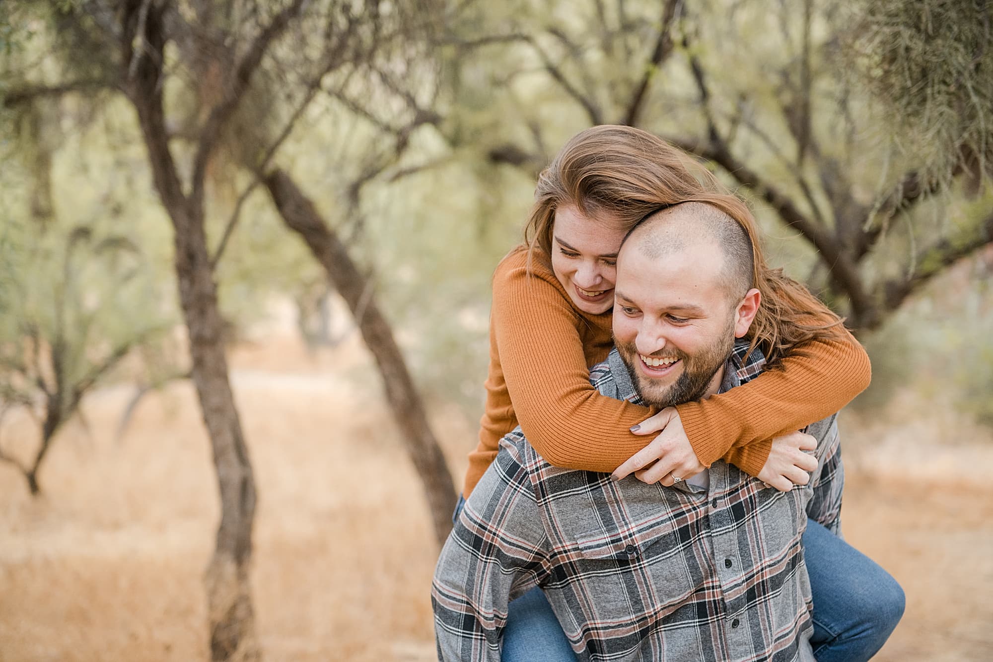Warm fall engagement session at Coon Bluff couple having fun